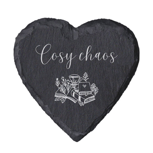 Heart-shaped slate coaster with 'Cosy chaos' text and illustrations on a white background