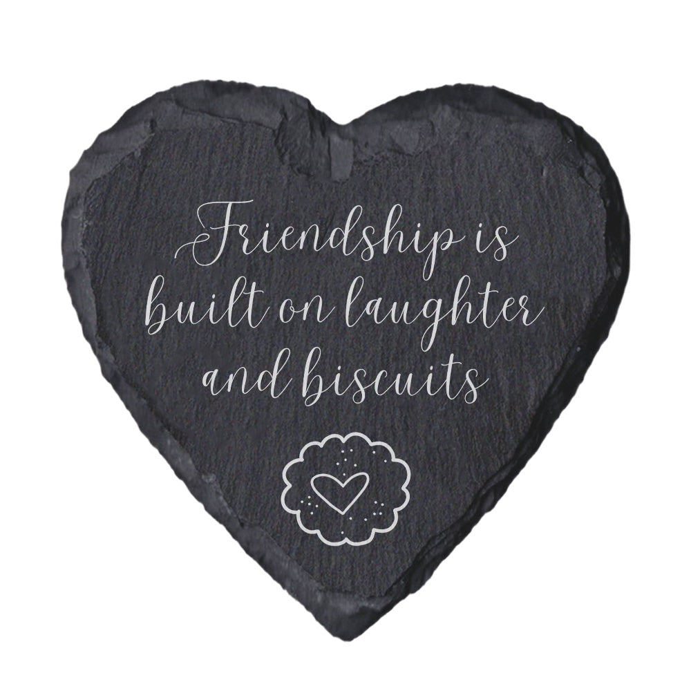 Heart-shaped slate coaster with 'Friendship is built on laughter and biscuits' text