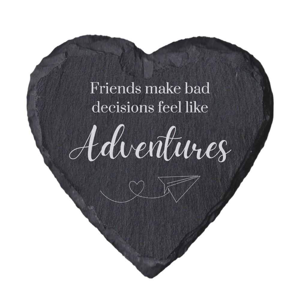 Heart-shaped slate coaster with engraved text and airplane illustration on a white background