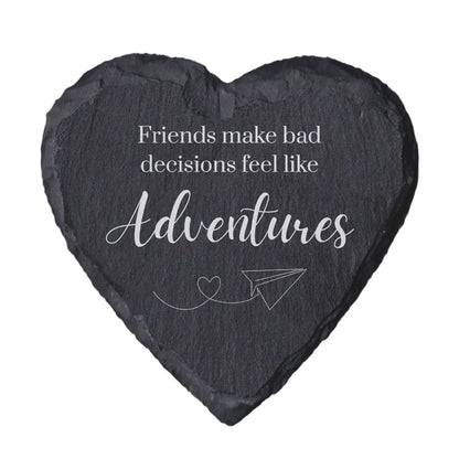 Heart-shaped slate coaster with engraved text and airplane illustration on a white background