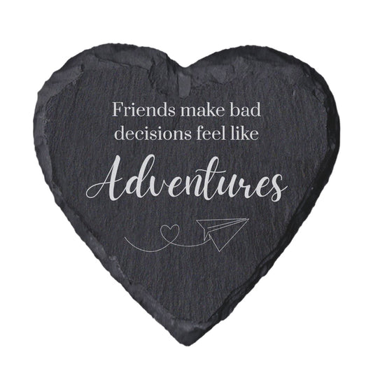 Heart-shaped slate coaster with engraved text and airplane illustration on a white background