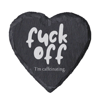 Heart-shaped slate coaster with text 'f*ck off I'm caffeinating' on a white background