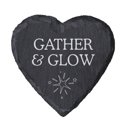 Heart-shaped slate coaster with 'Gather & Glow' text and star design on a white background