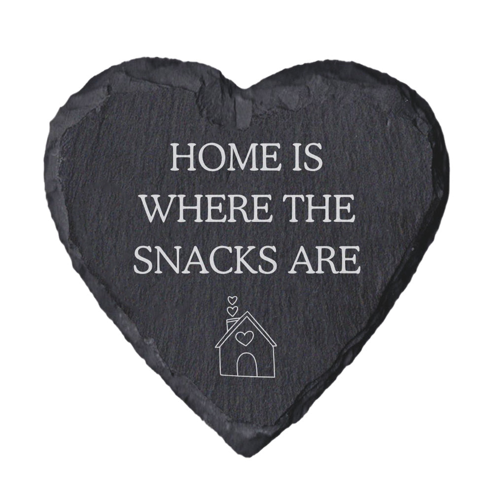 Heart-shaped slate coaster with 'Home is where the snacks are' text on a white background