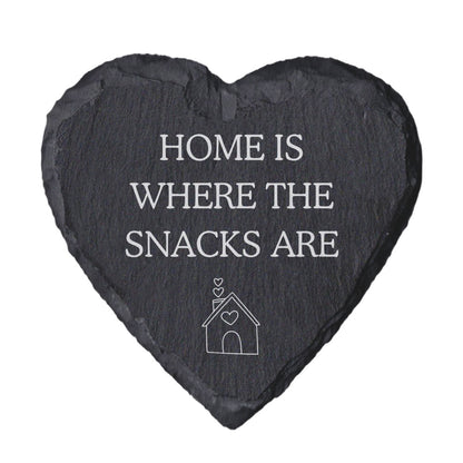 Heart-shaped slate coaster with 'Home is where the snacks are' text on a white background
