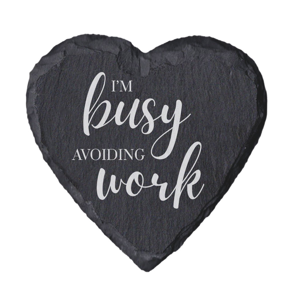 Heart-shaped slate coaster with 'I'm busy avoiding work' text on a white background