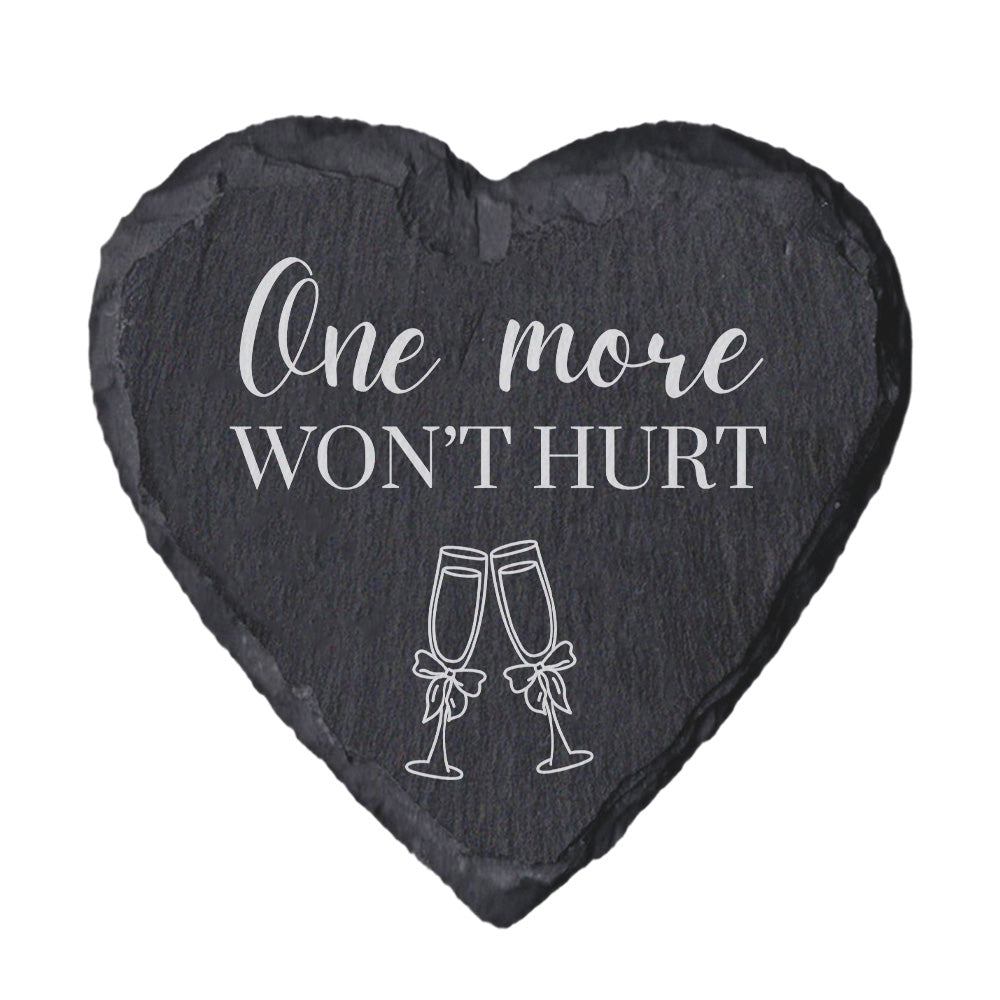 Heart-shaped slate coaster with 'One more won't hurt' text and champagne glass illustrations on a white background