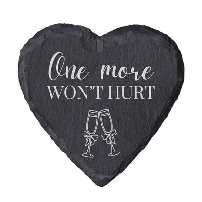 Heart-shaped slate coaster with 'One more won't hurt' text and champagne glass illustrations on a white background
