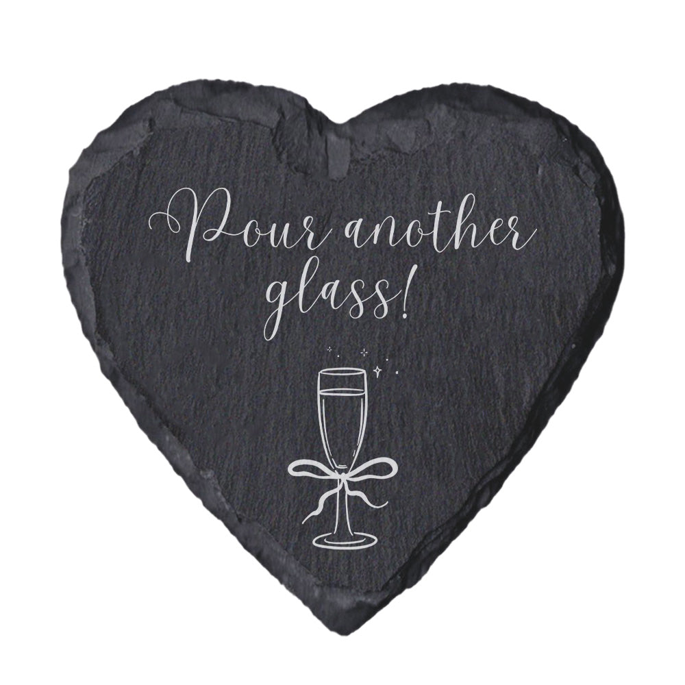 Heart-shaped slate coaster with 'Home is where the snacks are' text on a white background