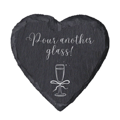 Heart-shaped slate coaster with 'Home is where the snacks are' text on a white background