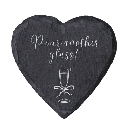 Heart-shaped slate coaster with 'Home is where the snacks are' text on a white background