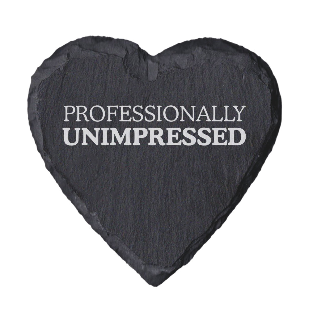 Heart-shaped slate coaster with 'PROFESSIONALLY UNIMPRESSED' text on a white background