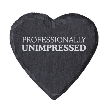 Heart-shaped slate coaster with 'PROFESSIONALLY UNIMPRESSED' text on a white background