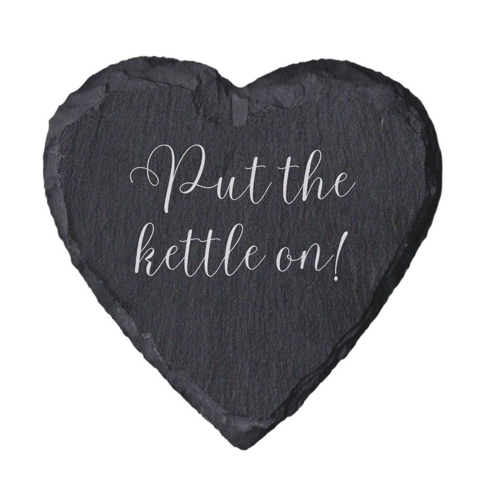Heart-shaped slate coaster with 'Put the kettle on!' text on a white background