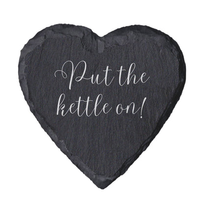 Heart-shaped slate coaster with 'Put the kettle on!' text on a white background