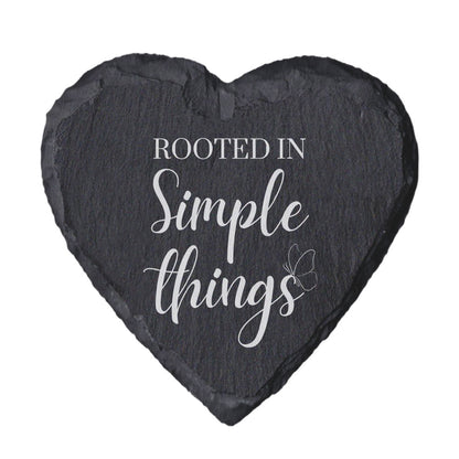 Heart-shaped slate coaster with 'Rooted in Simple Things' text on a white background