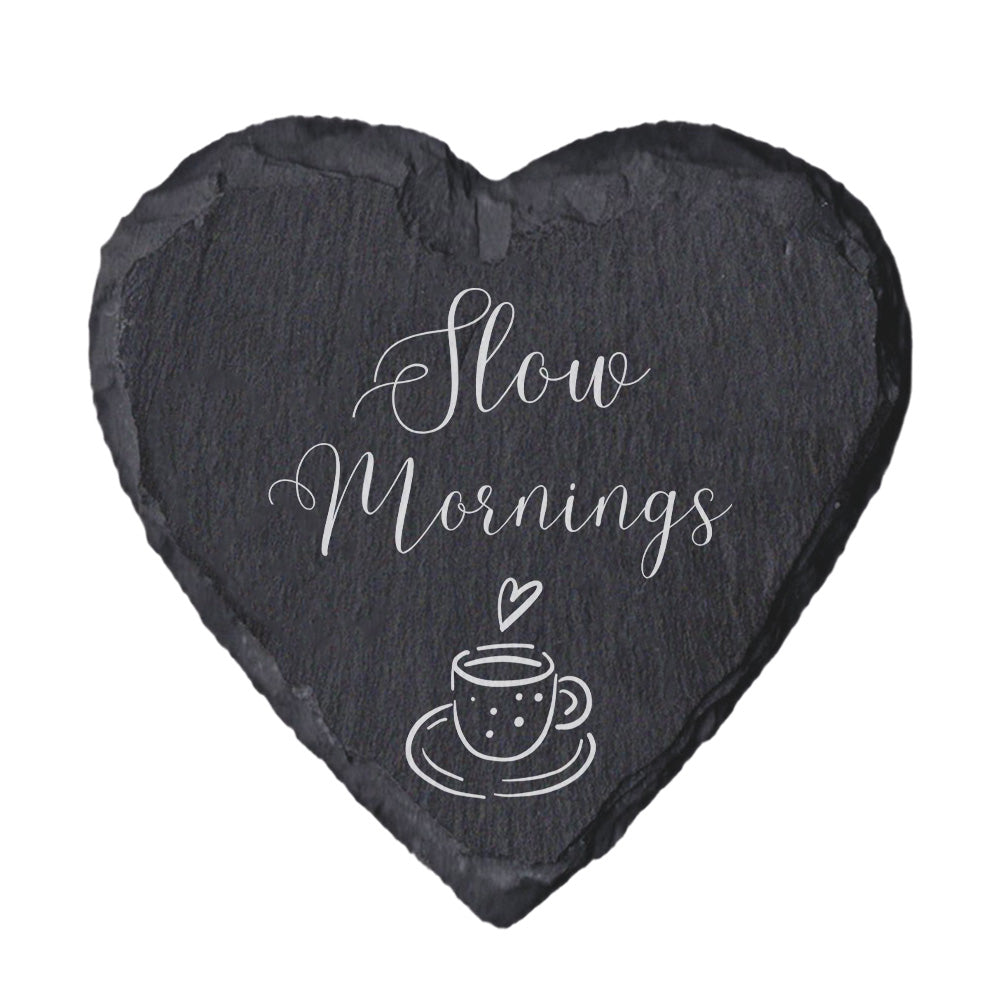 Heart-shaped slate coaster with 'Slow mornings' text on a white background