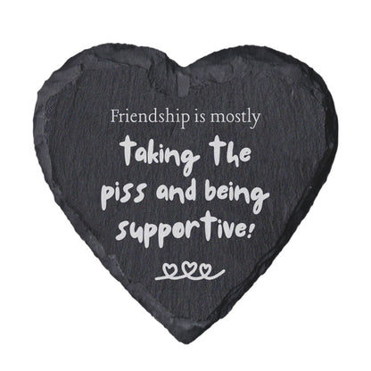 Heart-shaped slate coaster with humorous friendship quote on a white background