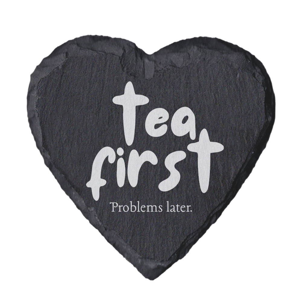Heart-shaped slate coaster with 'Tea first, Problems later.' text on a white background