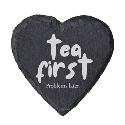 Heart-shaped slate coaster with 'Tea first, Problems later.' text on a white background