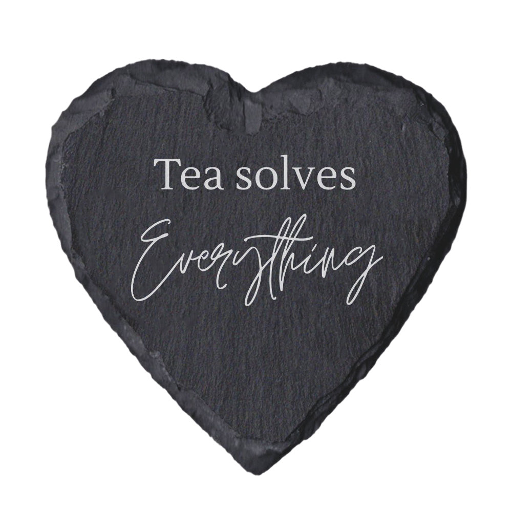Heart-shaped slate coaster with 'Tea solves Everything' text on a white background