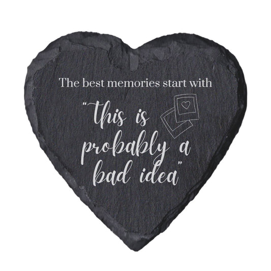 Heart-shaped slate coaster with quote "The best memori9es start with this is probably a bad idea" on a white background