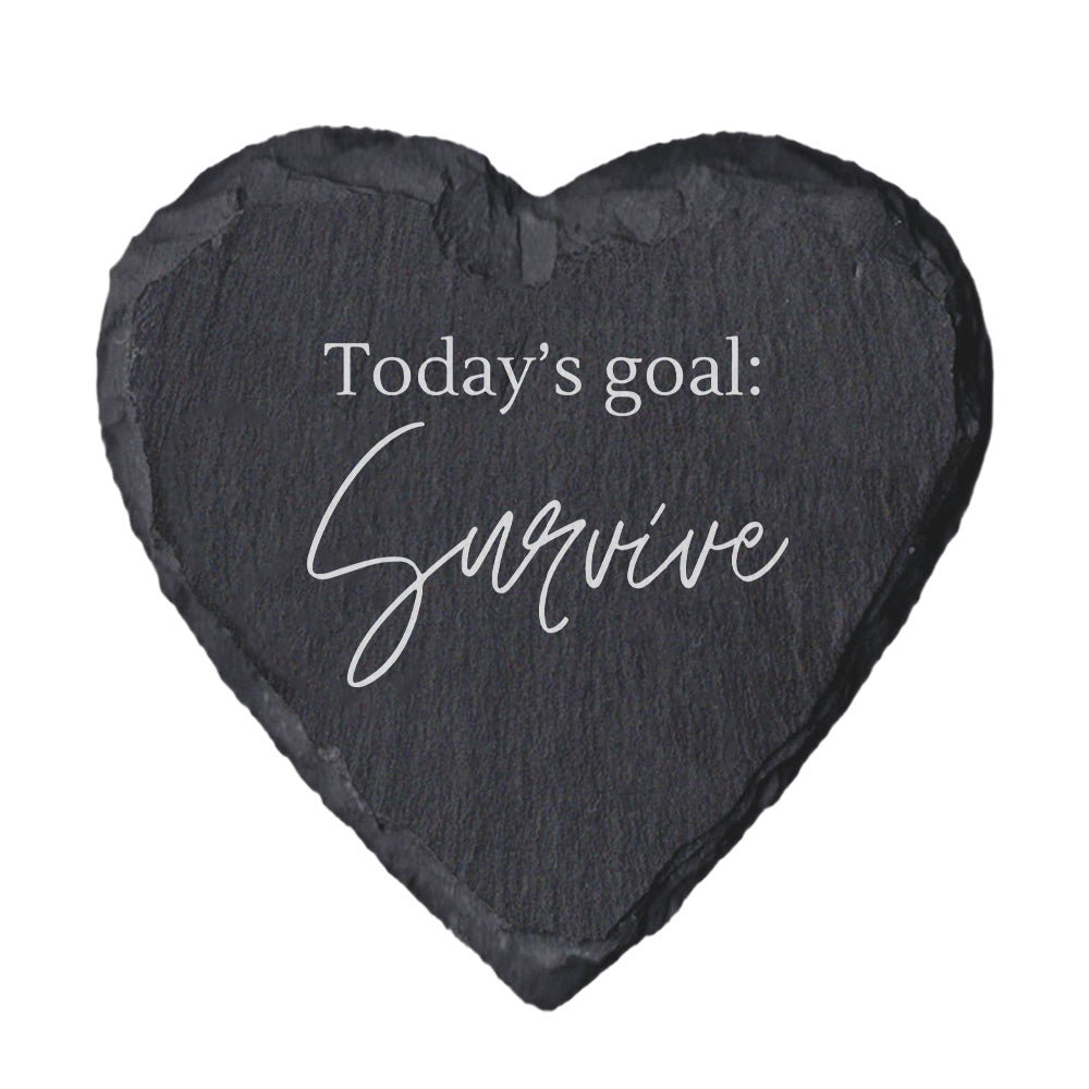 Heart-shaped slate coaster with 'Today's goal: Survive' text on a white background