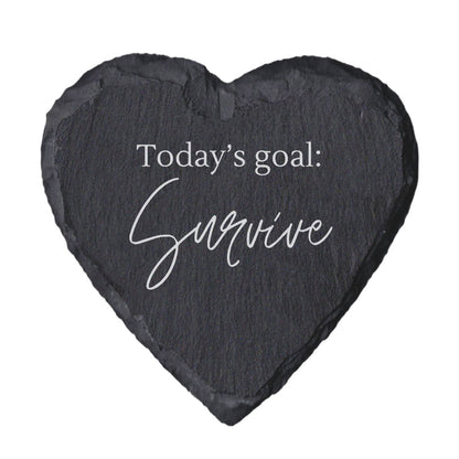 Heart-shaped slate coaster with 'Today's goal: Survive' text on a white background