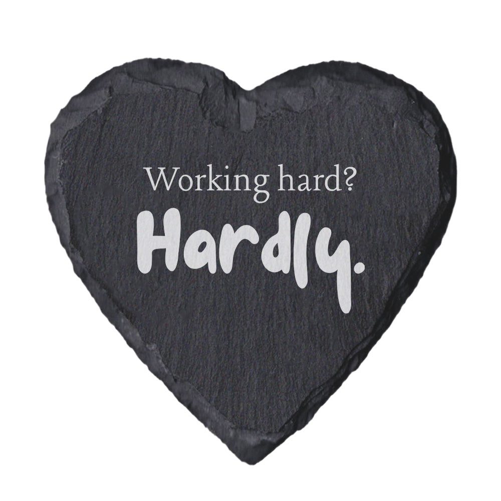 Heart-shaped slate coaster with 'Working hard? Hardly.' text on a white background