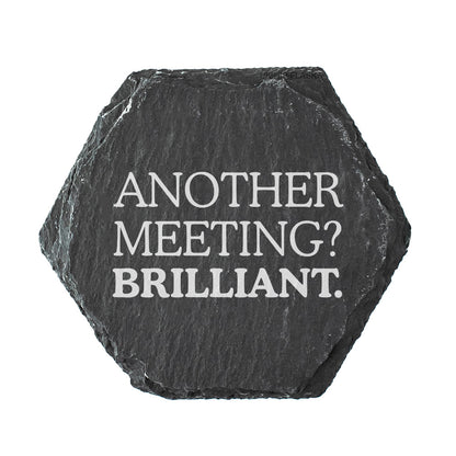 Hexagonal black slate coaster with white text 'Another Meeting? Brilliant.' on a white background