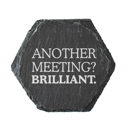 Hexagonal black slate coaster with white text 'Another Meeting? Brilliant.' on a white background