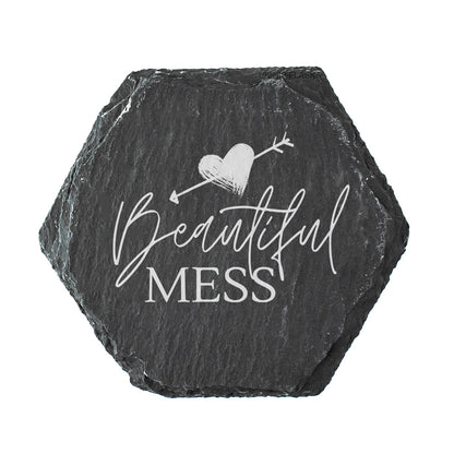 Hexagonal black slate slate coaster with 'Beautiful Mess' text and heart design on a white background