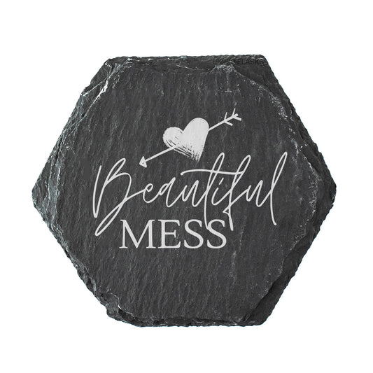 Hexagonal black slate slate coaster with 'Beautiful Mess' text and heart design on a white background