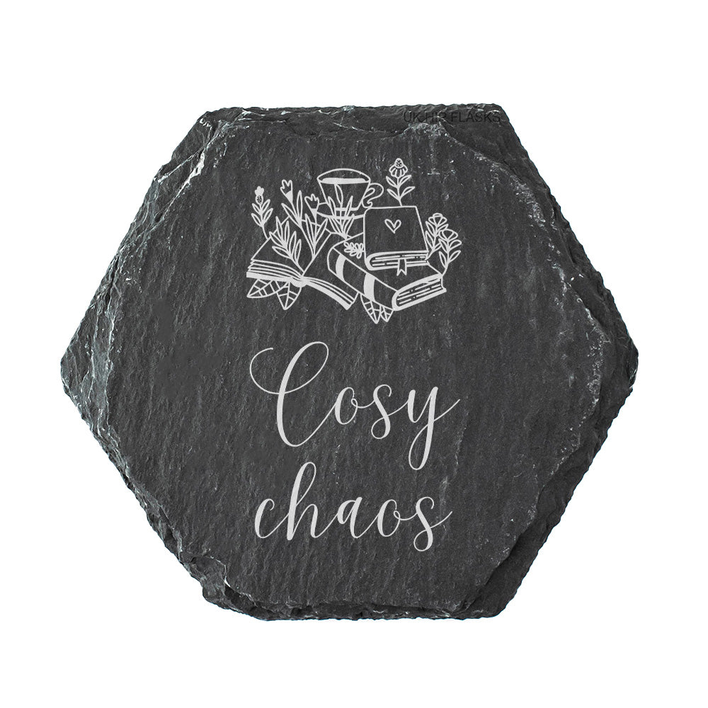 Hexagonal black slate coaster with white text design and text 'Cosy chaos' on a white background