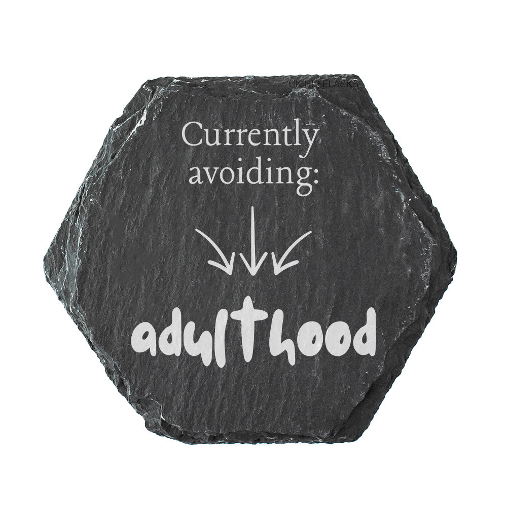 Hexagonal black slate coasters with white text 'Currently avoiding: adulthood'