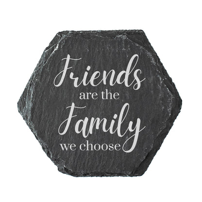 Hexagonal slate coaster with white text 'Friends are the family we choose' on a white background