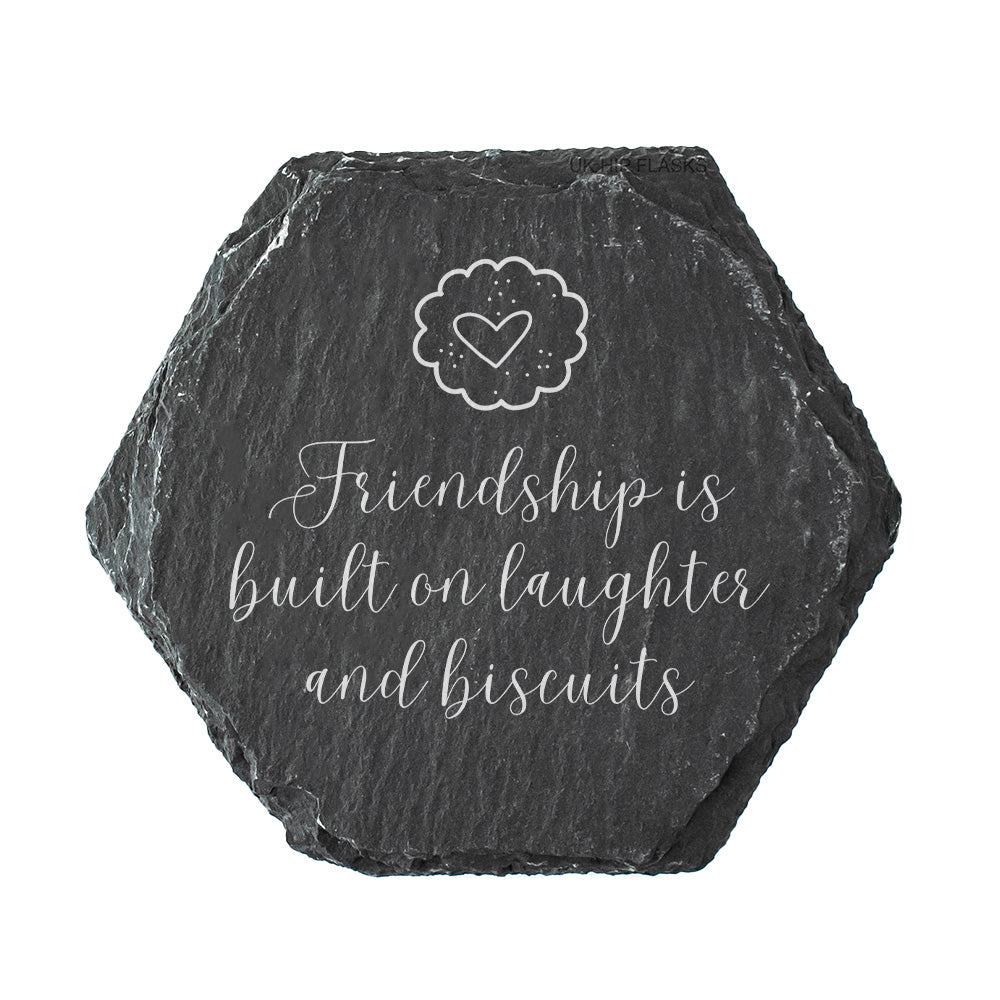 Hexagonal slate coaster with 'Friendship is built on laughter and biscuits' text and a heart design.