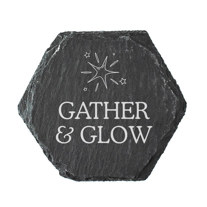 Hexagonal black slate coaster with 'Gather & Glow' quote on a white background
