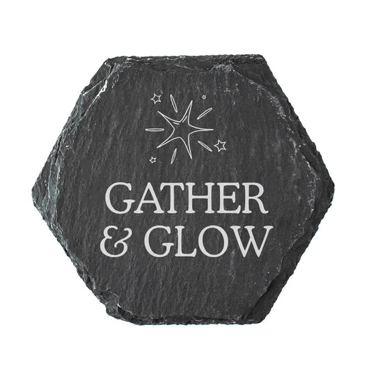 Hexagonal black slate coaster with 'Gather & Glow' quote on a white background