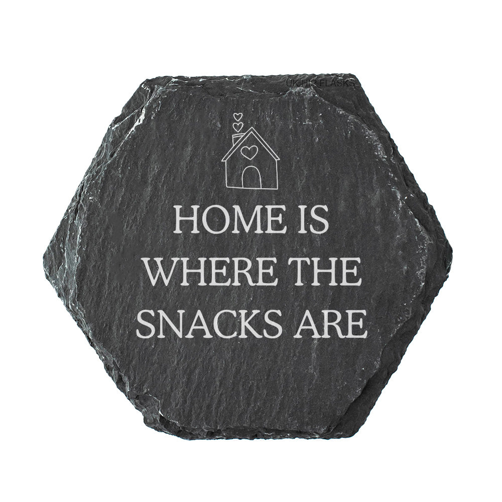Hexagonal black slate coaster with 'Home is where the snacks are' text on a white background