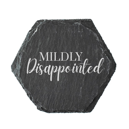 Hexagonal black slate coaster with 'Mildly Disappointed' text on a white background