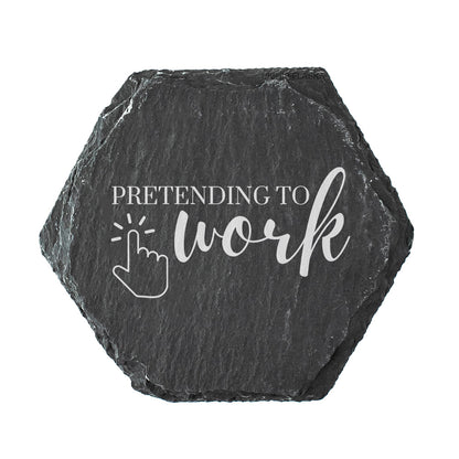 Hexagonal black slate coaster with 'Pretending to work' text and cursor icon on a white background