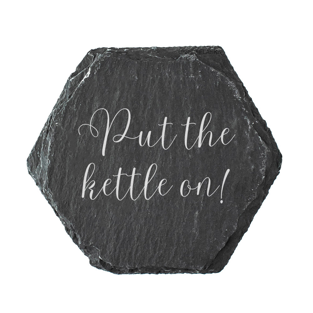 Hexagonal slate coaster with the quote "put the kettle on!" in white text.