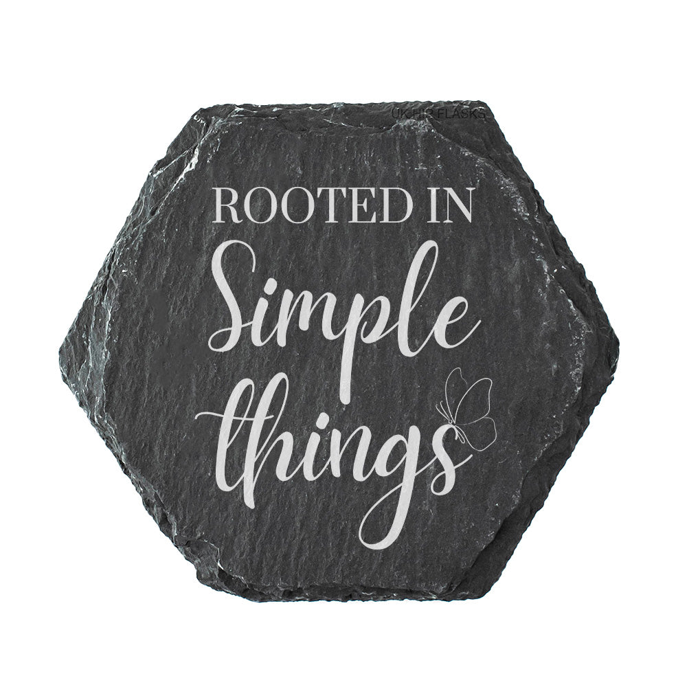 Hexagonal slate coaster with 'Rooted in Simple Things' text on a white background