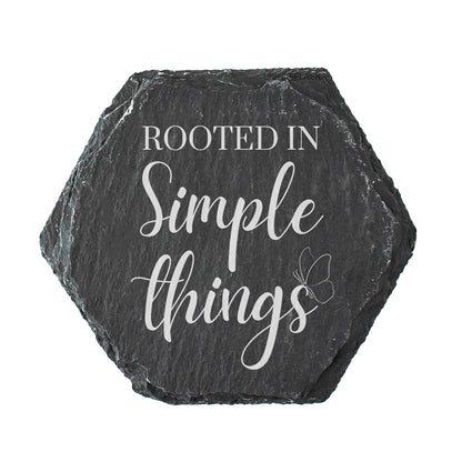 Hexagonal slate coaster with 'Rooted in Simple Things' text on a white background