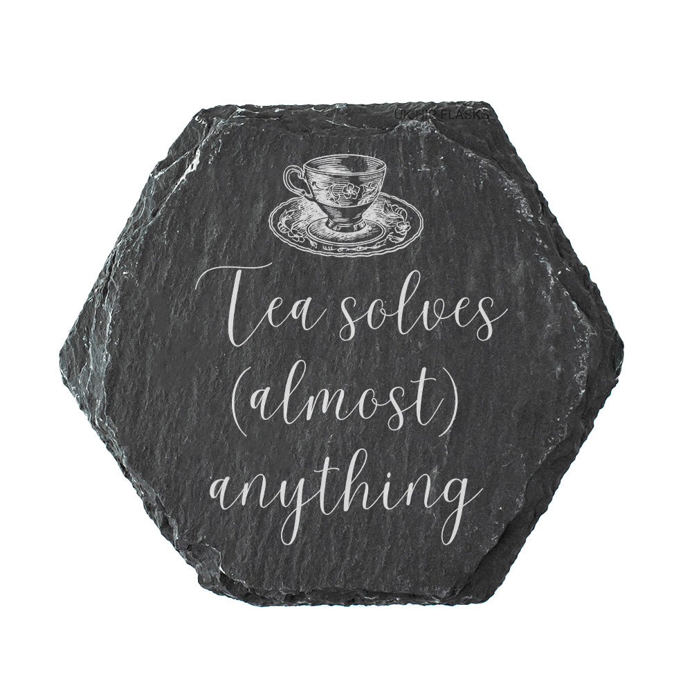 Hexagonal slate coaster with a tea cup illustration and text 'Tea solves (almost) anything' on a white background.