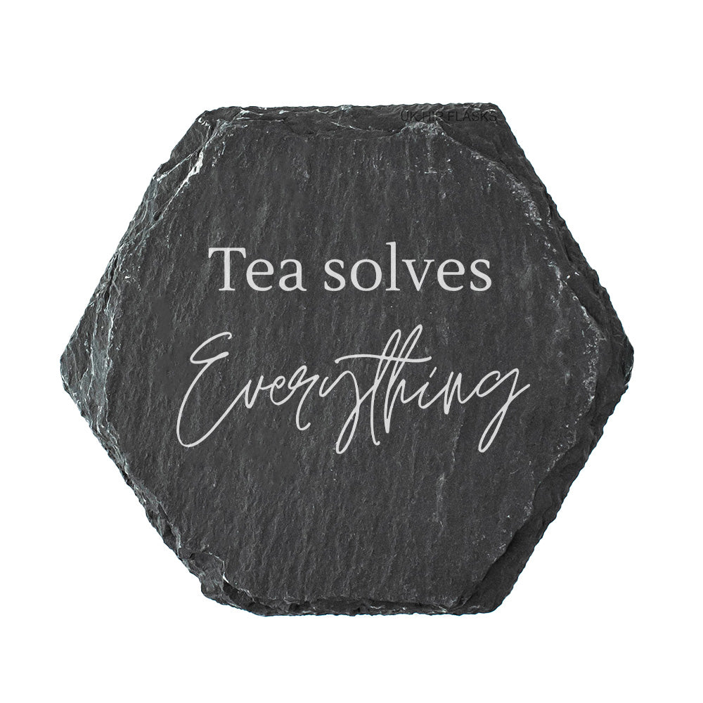 Hexagonal black slate coaster with 'Tea solves Everything' text on a white background