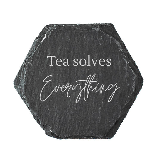 Hexagonal black slate coaster with 'Tea solves Everything' text on a white background