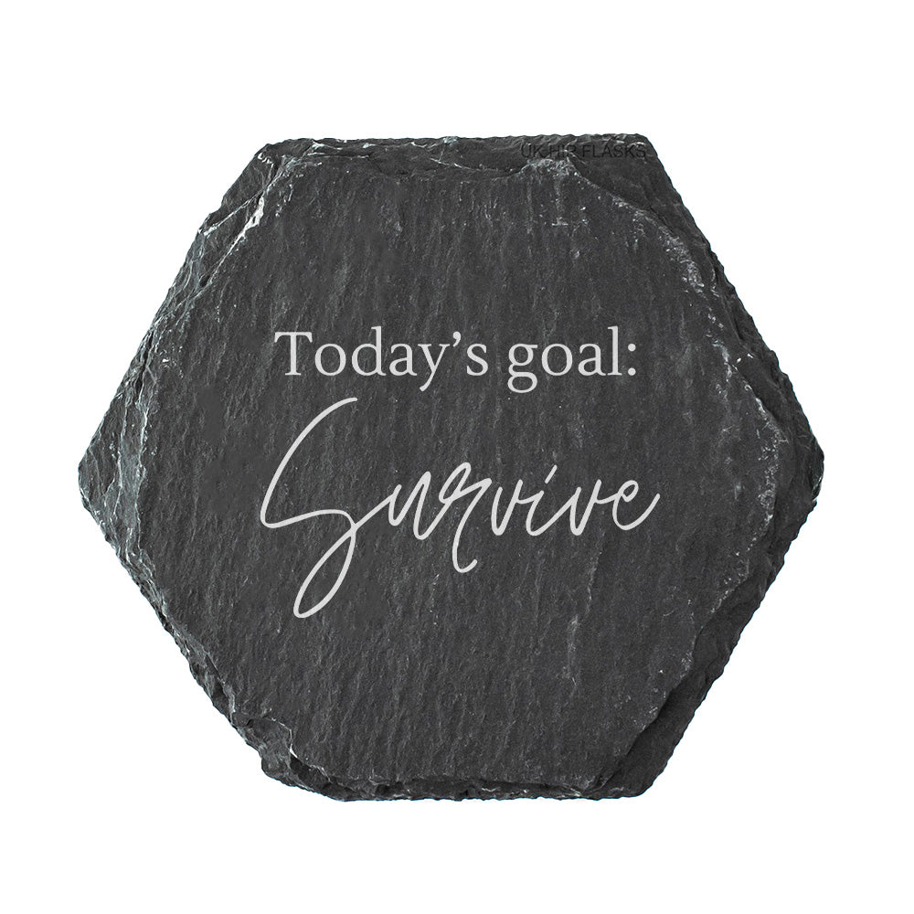 Hexagonal black slate coaster with 'Today's goal: Survive' text on a white background