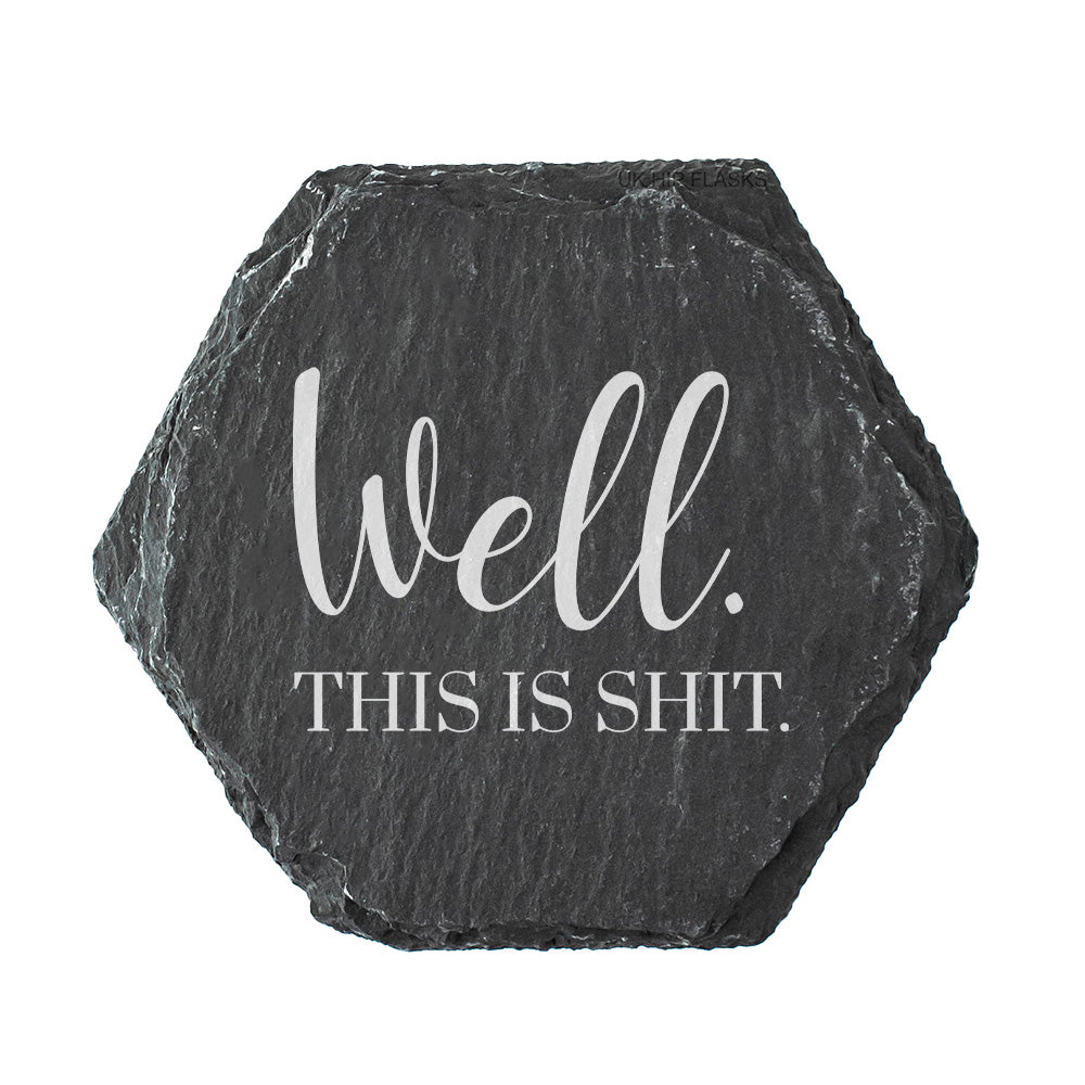 Hexagonal slate coaster with text 'Well. This is shit' on a white background